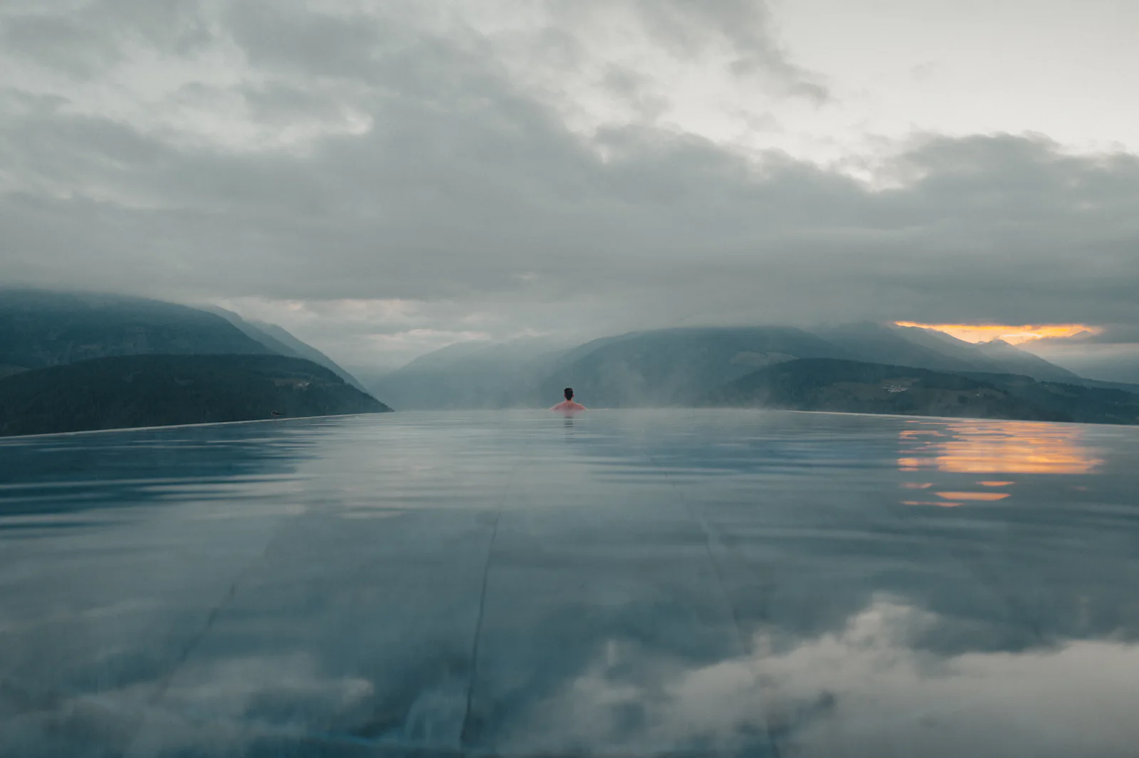 Becken am Hang, dahinter die Täler im Abendnebel